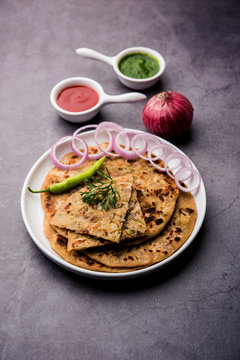 Onion Parotha / Pyaj parantha / kanda paratha served with tomato ketchup and green chutney. selective focus