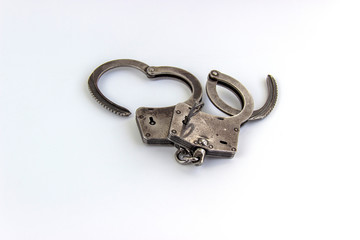 the key of the house in handcuffs, isolated on white background