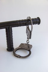real police handcuffs and baton isolated on white background