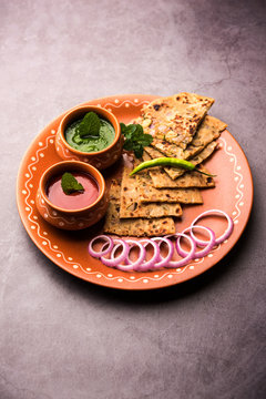 Onion Parotha / Pyaj parantha / kanda paratha served with tomato ketchup and green chutney. selective focus