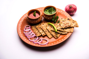 Onion Parotha / Pyaj parantha / kanda paratha served with tomato ketchup and green chutney. selective focus