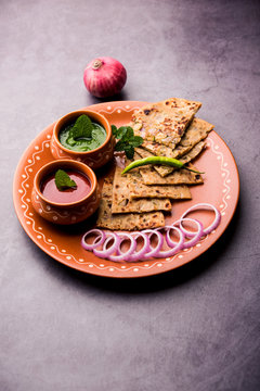 Onion Parotha / Pyaj parantha / kanda paratha served with tomato ketchup and green chutney. selective focus