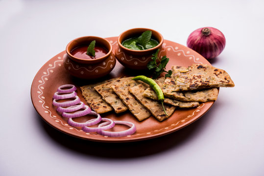 Onion Parotha / Pyaj parantha / kanda paratha served with tomato ketchup and green chutney. selective focus