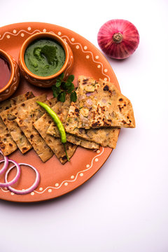 Onion Parotha / Pyaj parantha / kanda paratha served with tomato ketchup and green chutney. selective focus
