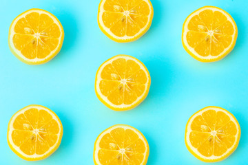 Fototapeta na wymiar Summer and vitamins background. Lemon on a blue background, minimal food concept