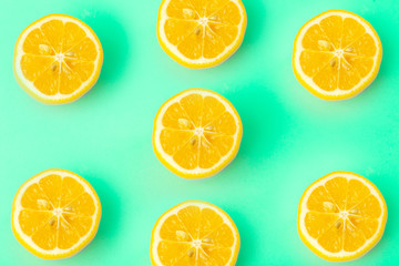 Fototapeta na wymiar Summer and vitamins background. Lemon on a green background, minimal food concept