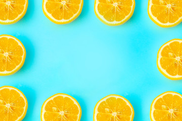 Summer and vitamins background frame. Lemon on a blue background, minimal food concept