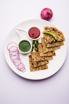 Onion Parotha / Pyaj parantha / kanda paratha served with tomato ketchup and green chutney. selective focus