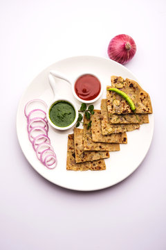 Onion Parotha / Pyaj parantha / kanda paratha served with tomato ketchup and green chutney. selective focus