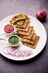 Onion Parotha / Pyaj parantha / kanda paratha served with tomato ketchup and green chutney. selective focus