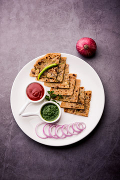 Onion Parotha / Pyaj parantha / kanda paratha served with tomato ketchup and green chutney. selective focus
