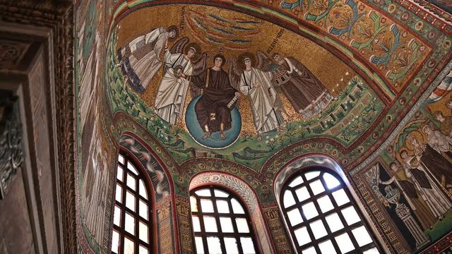 Ravenna, Italy, December 2019. Inside the basilica of San Vitale, footage with tilt movement on the apse decorated with magnificent mosaics.