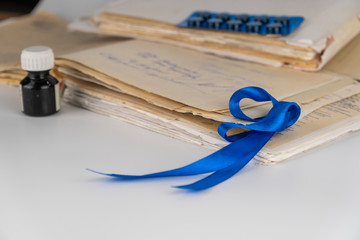 dark blue awareness ribbon on white background.