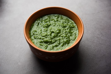 Kothimbir or Dhaniya Chutney made using Cilantro or coriander with chilli, served in a bowl. selective focus