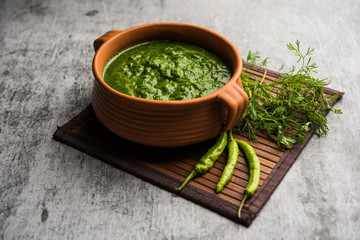 Kothimbir or Dhaniya Chutney made using Cilantro or coriander with chilli, served in a bowl. selective focus
