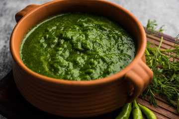 Kothimbir or Dhaniya Chutney made using Cilantro or coriander with chilli, served in a bowl. selective focus