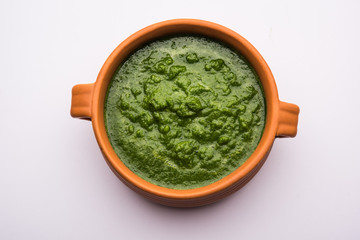 Kothimbir or Dhaniya Chutney made using Cilantro or coriander with chilli, served in a bowl. selective focus