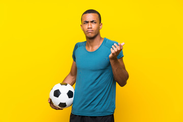 African American football player man making doubts gesture while lifting the shoulders