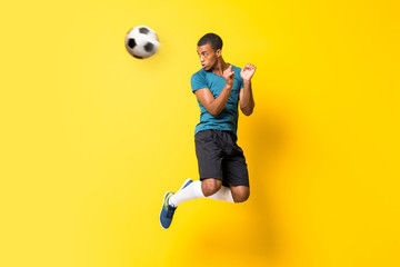 Afro American football player man over isolated yellow background