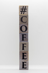Coffee written on wooden blocks isolated on light grey background