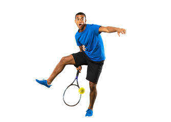 Full-length shot of African American tennis player man over isolated white background © luismolinero