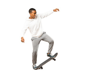 Full-length shot of Afro American skater man over isolated white background