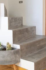 Microcement grey colour on staircase with matt finish, in combination with white walls and natural...