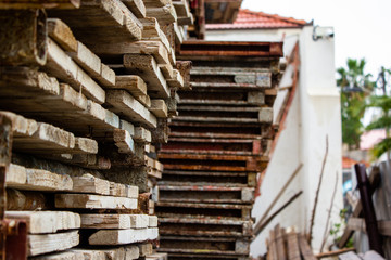 Industrial wooden pallets stack. Industrial wooden beams in the factory warehouse laid in neat rows. Long shot of neat rows industrial wooden pallets stack on a construction site.