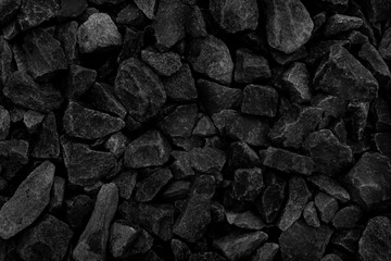 Natural fire ashes with dark grey black coals texture. It is a flammable black hard rock. Space for text.