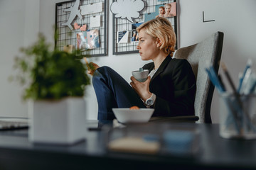 Attractive lady looking on note in her office