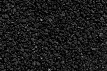 Fototapeta premium Natural fire ashes with dark grey black coals texture. It is a flammable black hard rock. Space for text.
