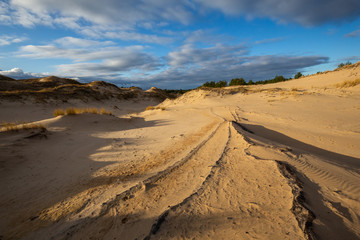 Fototapeta na wymiar Dunes in the Slowinski National Park. Landscape with beautiful sky, clouds and dunes in the sun. Czolpino, Leba, Poland.
