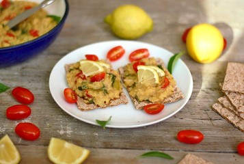 Dry bread spread with paste of red lentils, tomato, basil and lemon