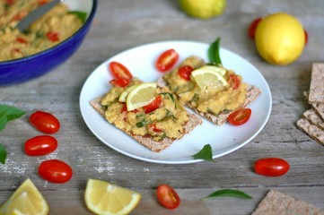 Dry bread spread with paste of red lentils, tomato, basil and lemon