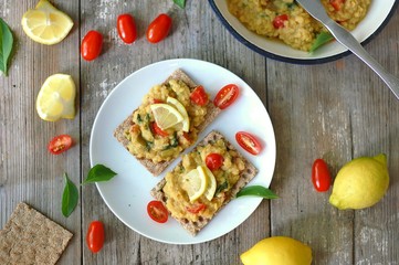 Dry bread spread with paste of red lentils, tomato, basil and lemon