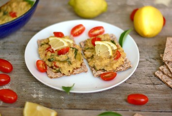Dry bread spread with paste of red lentils, tomato, basil and lemon