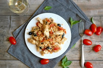 Couscous salad with chicken fillets, black olive, tomato and white wine