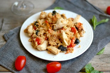 Couscous salad with chicken fillets, black olive, tomato and white wine