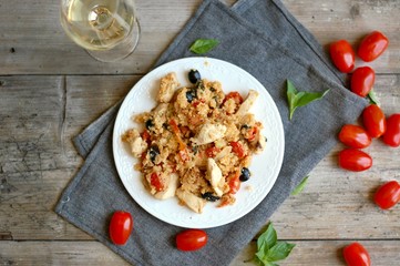 Couscous salad with chicken fillets, black olive, tomato and white wine