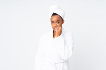 African american woman  in a bathrobe over isolated background nervous and scared