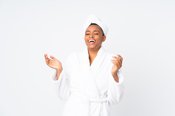 African american woman  in a bathrobe over isolated background laughing