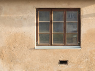 painted wall with wooden frame window. 