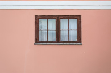 painted wall with wooden frame window. 