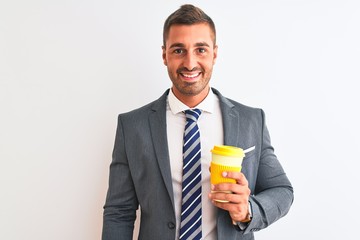 Young handsome business man drinking take away coffee over isolated background with a happy face standing and smiling with a confident smile showing teeth