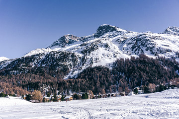 Snowy mountains during a sunny winter day in the alps, near the village of Sankt Moritz and Silvaplana, Switzerland - January 2020