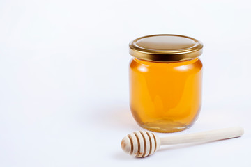 jar of honey isolated on white