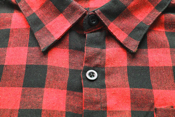 Checkered plaid shirt close up, red and black tartan pattern clothes. Detail of casual stylish...