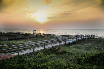 Fototapeta na wymiar Walkway at the beach at sunset / sunrise
