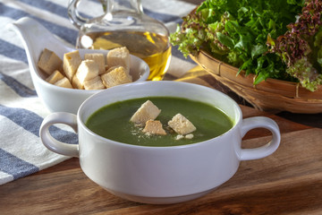 Spinach Soup with Bread in a White Bowl