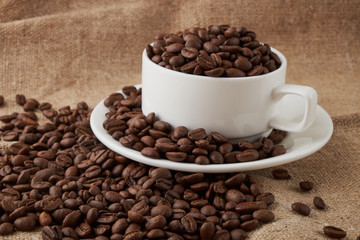 Coffee Cup and coffee beans on the table close-up